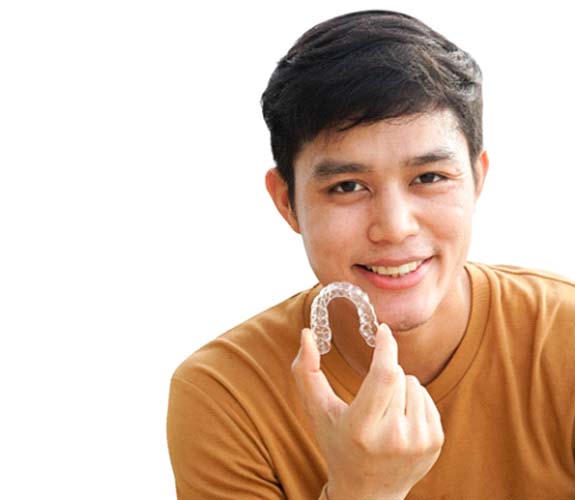 Boy holding Invisalign Teen in Sycamore